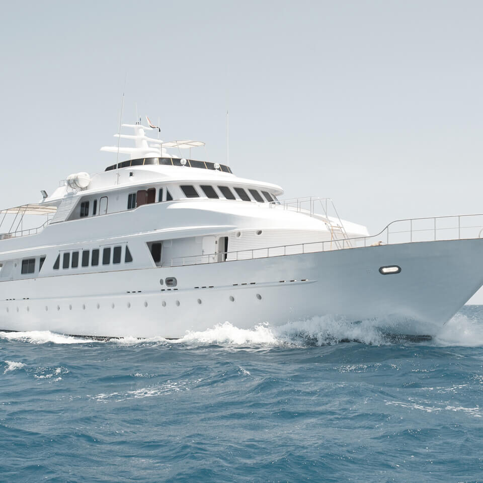 A white motor yacht sailing in the ocean.