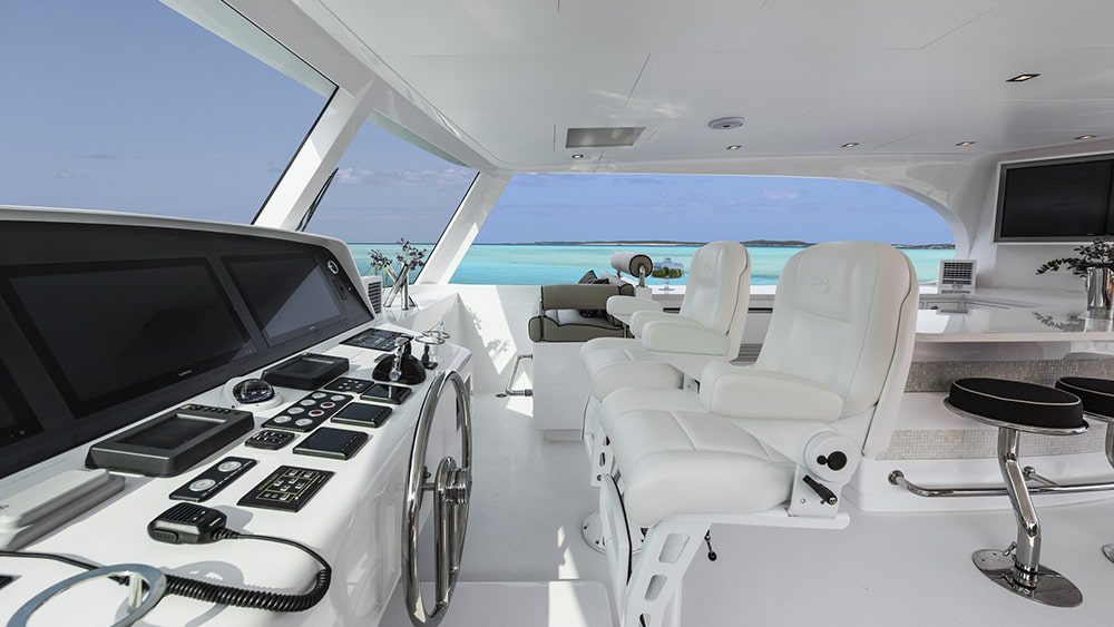 The interior of a white boat with a view of the ocean.