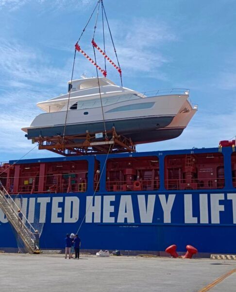 A Horizon PC60 boat being lifted by a crane during a sea trial video.